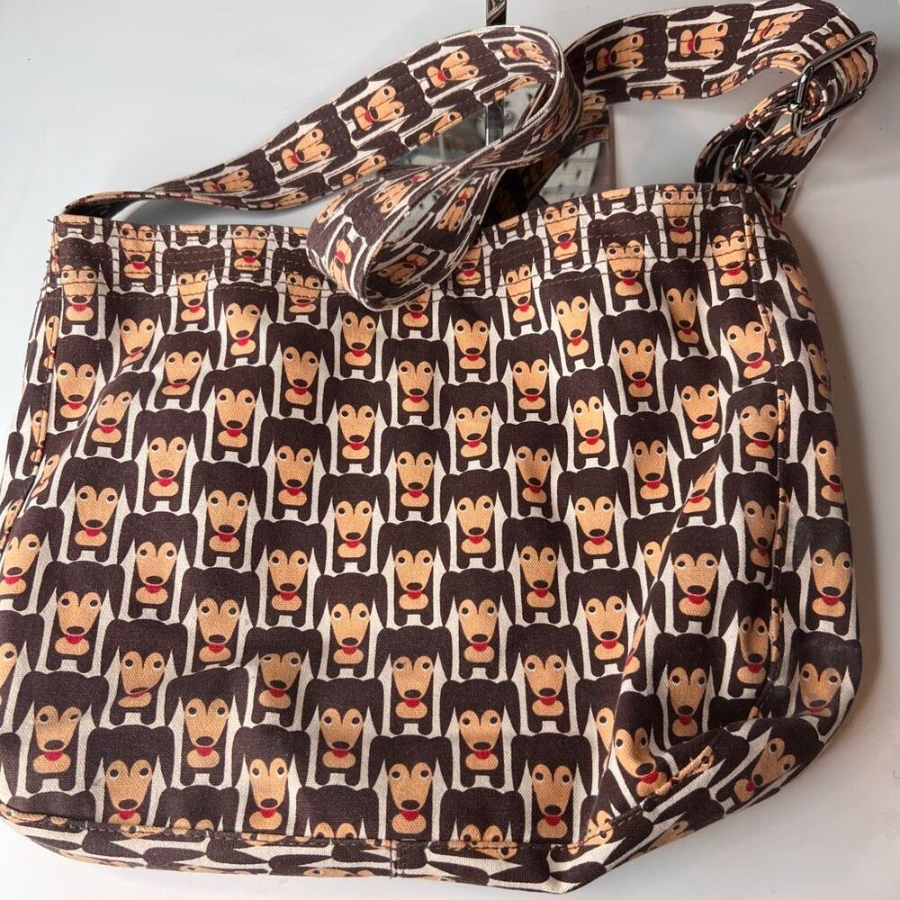 Bungalow360 messenger bag features a playful "Happy Dog" dachshund pattern on du